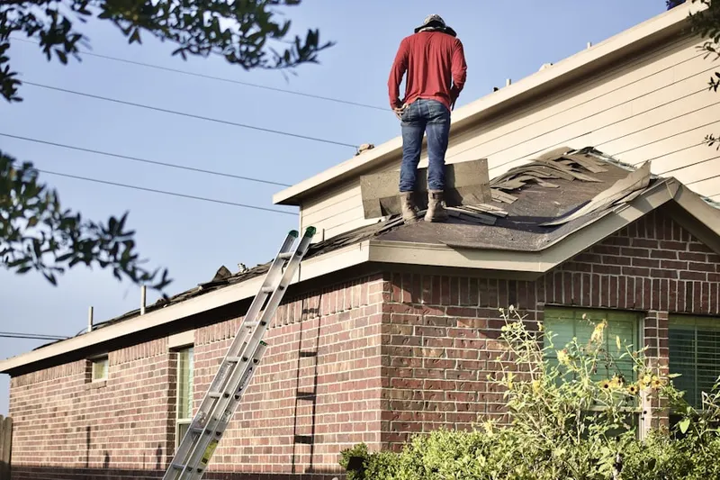 Professional roofer working on a residential roof in Bastrop